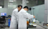 Two men inspecting a lab